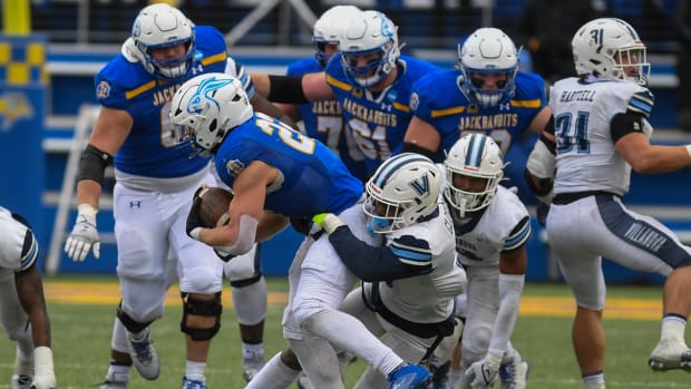 SDSU's running back Isaiah Davis (22) gets tackled by a Villanova player on Saturday, Dec. 9, 2023 at Dana J. Dykhouse in Brookings.